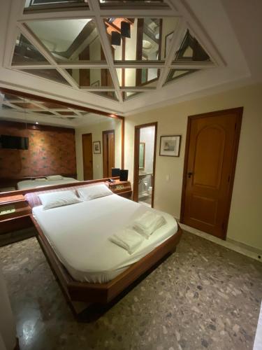 a bedroom with a large white bed in a room at Megara in Rio de Janeiro