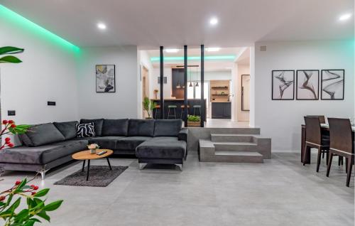 a living room with a couch and a table at 4 Bedroom Gorgeous Apartment In Medulin in Medulin