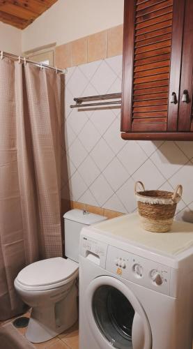 a bathroom with a washing machine and a toilet at Το Αρχοντικό του Κάστρου in Kyparissia