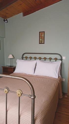 a bedroom with a bed with a metal head board at Το Αρχοντικό του Κάστρου in Kyparissia