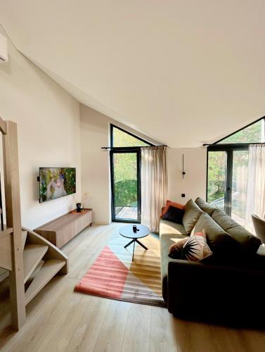 a living room with a couch and a table at LEX apartments in Palanga