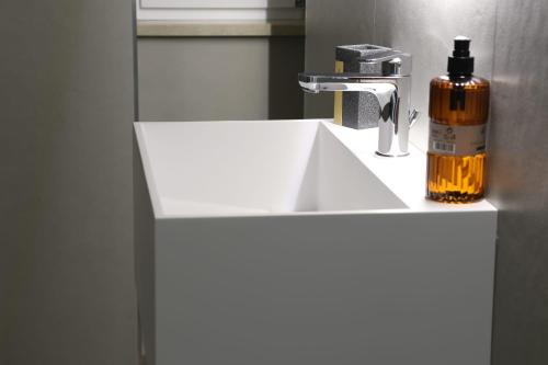 a white bathroom sink with a soap bottle on it at Domus Mamurra in Formia