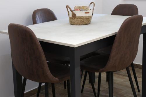 a table with four chairs and a basket on top at Domus Mamurra in Formia