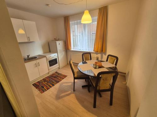 a kitchen and dining room with a table and chairs at Old Town Bistrik - Free parking in Sarajevo