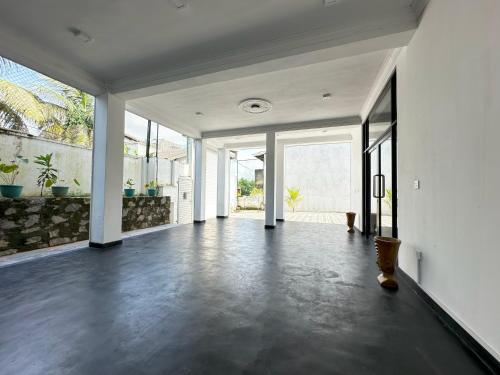an empty living room with white walls and large windows at Large 4 Bedroom Spacious Apartment in Nugegoda, Colombo in Nugegoda