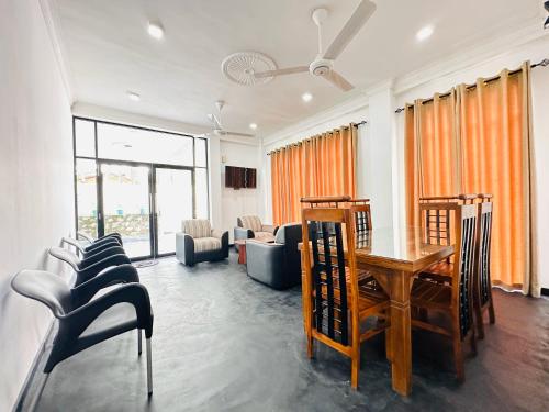 a living room with a table and chairs at Large 4 Bedroom Spacious Apartment in Nugegoda, Colombo in Nugegoda