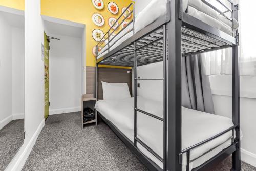 a bedroom with two bunk beds in a room at Heeton Concept Hotel - Kensington London in London