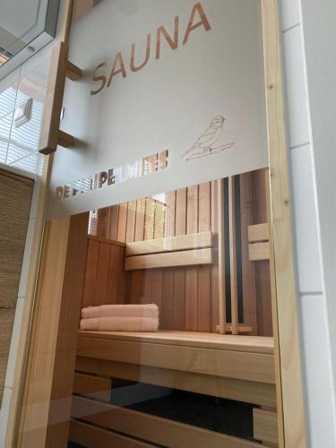 a store window with a sign for a sauna at The Pimpelmees in Hoge-Hexel