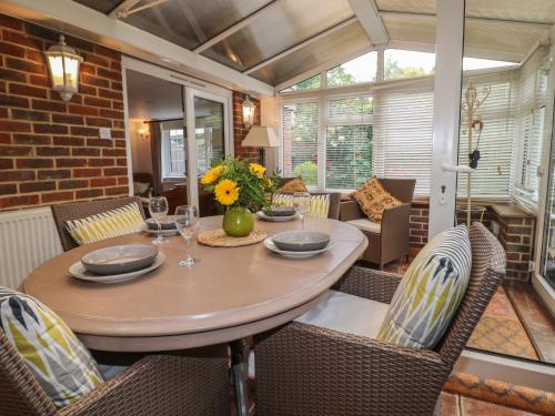 a dining room with a table and chairs at Woodend Annexe in Slindon