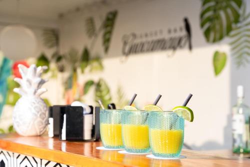 two glasses of orange juice sitting on a counter at HOVIMA Jardin Caleta in Adeje