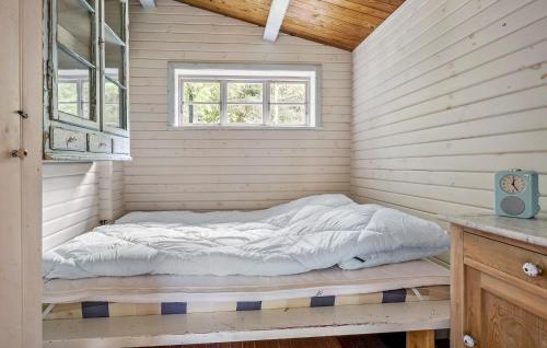 a bed in a room with a window at 1 Bedroom Cozy Home In Nykøbing Sj in Nykøbing Sjælland