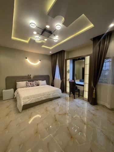 a bedroom with a bed and a ceiling with lights at Virtue Villa in Port Harcourt