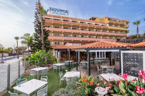 a view of a hotel with tables and chairs at HOVIMA Jardin Caleta in Adeje