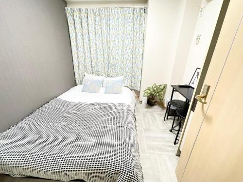 Ένα ή περισσότερα κρεβάτια σε δωμάτιο στο シャンテ高田馬場12