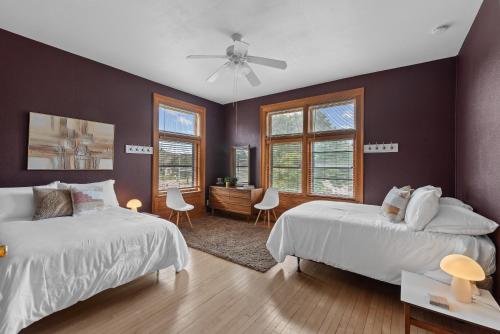 a bedroom with two beds and a ceiling fan at The Uplifting Mansion in Milwaukee