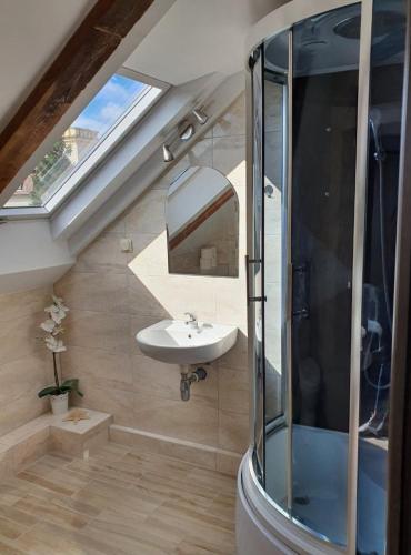 a bathroom with a sink and a window at Syrenka Apartamenty in Ustka