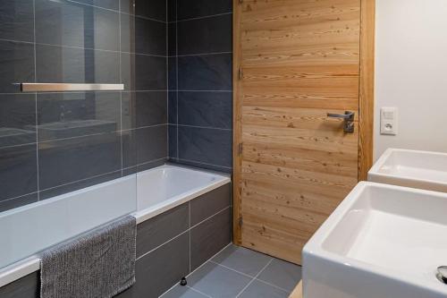 a bathroom with a tub and a sink at La Java in Villard-Reculas