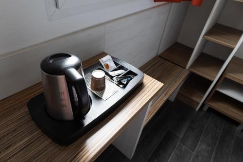 a coffee maker sitting on a table in a room at Brit Hotel Confort Saint-Lô in Saint Lo