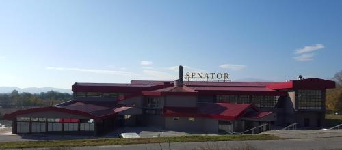 a building with a sign on the side of it at Casino Motel Senator in Gevgelija