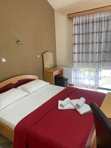 a bedroom with a large bed with two towels on it at Motel Krstac in Mojkovac