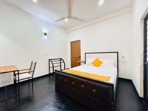 a bedroom with a bed and a table and a desk at Large 4 Bedroom Spacious Apartment in Nugegoda, Colombo in Nugegoda