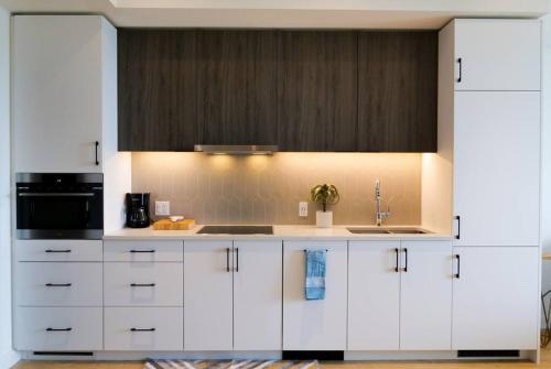 a kitchen with white cabinets and a sink at 2bhk Luxury brand new pvt suite Kitchener in Kitchener