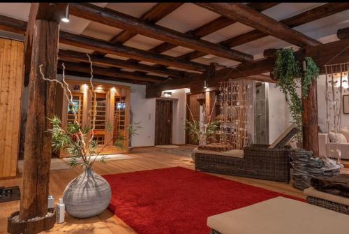 a living room with a vase on a red rug at Jagerbauerngut in Wimm