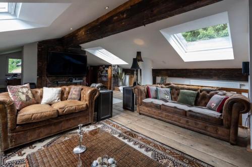 a living room with two couches and a television at Jagerbauerngut in Wimm