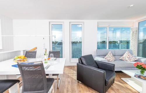 a living room with a couch and a table at Waterfront in Olpenitz