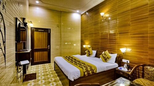 a bedroom with a large bed in a room at HOTEL HOLY CITY in Amritsar