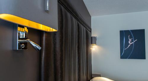 a room with a curtain and a yellow light at The Big Blue Hotel - Blackpool Pleasure Beach in Blackpool