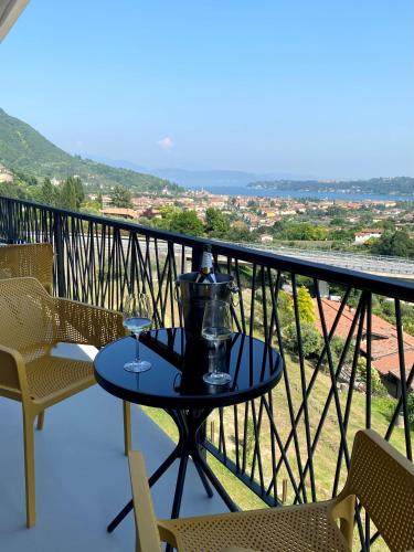 a table with two wine glasses on a balcony at Hotel Vita in Salò