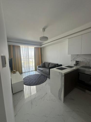 a kitchen and a living room with a couch at Grand Sapphire Resort Casino in Iskele