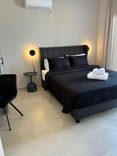 a bedroom with a bed with two towels on it at BEACH WHITE VILLAs in Minia