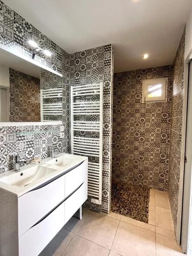 une salle de bain avec un lavabo blanc et une douche dans l'établissement Villa spacieuse à Sainte-Eulalie-en-Born, terrasse, piscine privée, à Sainte-Eulalie-en-Born