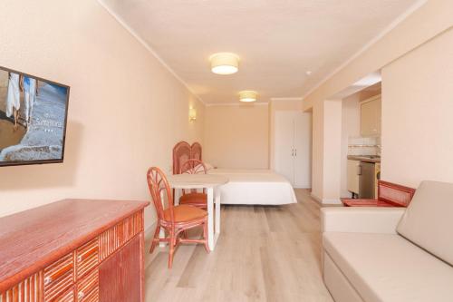 a room with a table and chairs and a bedroom at HOVIMA Santa María in Adeje
