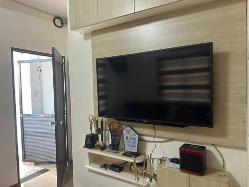 a flat screen tv on a wall in a living room at Nasugbu or Tuy - Entire House at RCD Royale Homes in Tuy