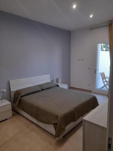 a bedroom with a large bed and a window at Apartment Emanuela in Porto Cesareo