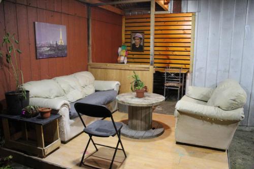 a living room with two couches and a table at Alojamiento Casa completa en Puerto Montt in Puerto Montt
