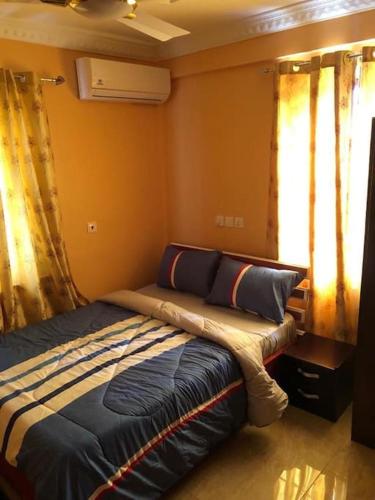 a bedroom with a bed in a room at Serene 2 bed with Wi-Fi and AC in Madina