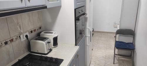 a small kitchen with a sink and a stove at Zamfira Home in Tulcea
