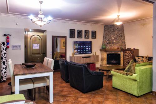 a living room with a table and a fireplace at Suite Rural Carenas in Carenas