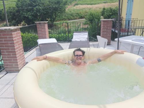 a man is in a jacuzzi tub at La Terrazza del Barbaresco in Neviglie