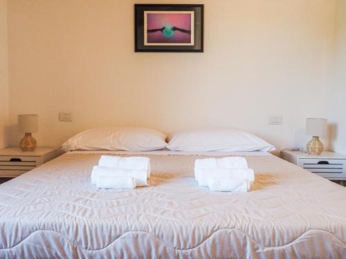 a bedroom with a large bed with towels on it at Casa vacanze Via Garibaldi in Narbolia