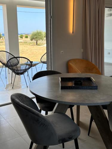 a table and chairs in a living room with a view at BEACH WHITE VILLAs in Minia