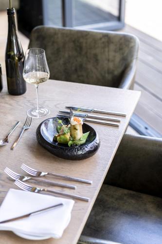 a plate of food on a table with a glass of wine at Weindomizil Hagn in Mailberg