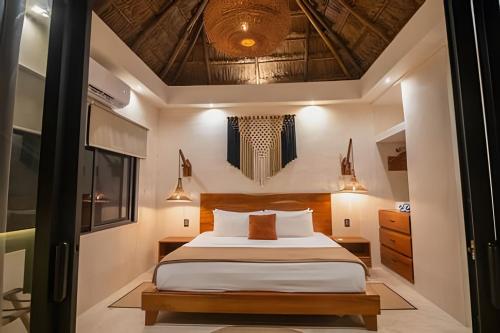 a bedroom with a bed and a ceiling with lights at Casa de Piedra - Departamentos Bacalar- in Bacalar