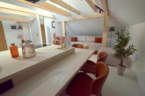 a living room with a table and chairs and a couch at Apartamenty Blanca in Łeba
