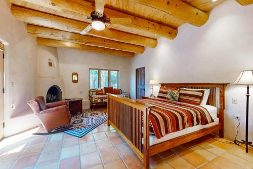 a bedroom with a bed and a living room at Casa del Sueños in Taos