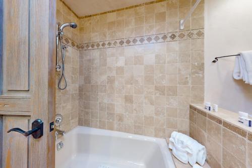 a bathroom with a white tub and a shower at Casa del Sueños in Taos